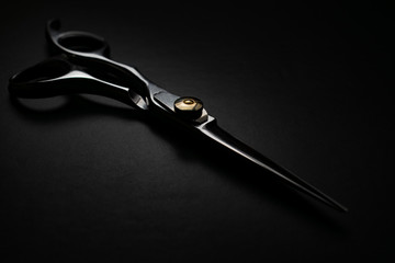professional scissors on black background