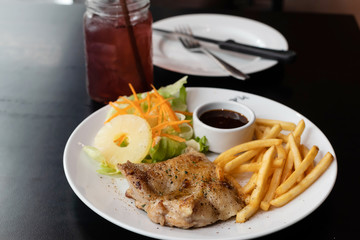 chicken steak with French fries and sauce on table
