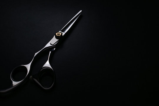 professional scissors on black background