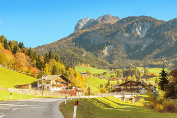 Naklejka premium Highway road in Dolomites mountains leading to small italian village
