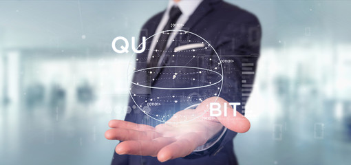Businessman holding Quantum computing concept with qubit icon 3d rendering