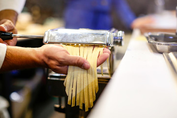 Chef making pasta with a machine, home made  fresh pasta