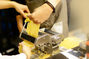 Chef making pasta with a machine, home made  fresh pasta