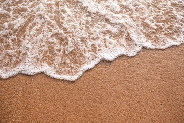Soft sea wave on beach sands with copy space area