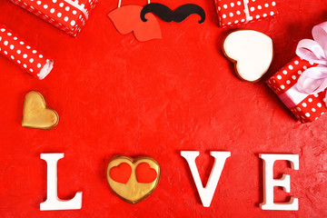 The word Love and a heart on a bright red background. view from above. Place for text