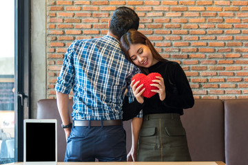 Two young asian couple of lover. Beautiful love couple Man and woman dating in cafe enjoy the time spend together with cellphone ,tablet computer. Flirting date people in a cafe,valentine day concept
