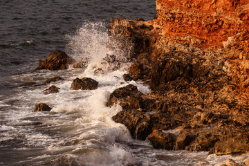 The wave arrives at the stony bank