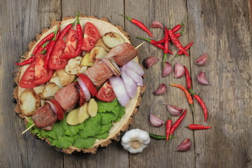 shashlik with ingredients on wooden background