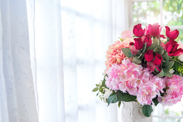 Beautiful pink- red roses flowers bouquet in vase on bride and groom table.Valentine day and romantic couple love concept .copy space