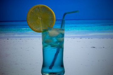 Blue Lagoon cocktail in highball glass with a straw