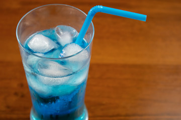 Blue Lagoon cocktail in highball glass with a straw