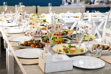 Served table in the restaurant with appetizers and salads 
