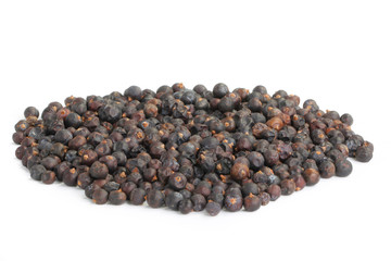 heap of black juniper berries isolated on white background