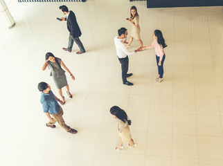 Top view of Young business people walking and standing separate discussion meeting on pathway before starting work in their office .Business communication lifestyle concept