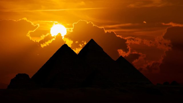 Egypt: The Great Pyramids Of Giza at Sunset, Time Lapse with Red Sun and Clouds, Cairo