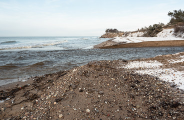 Entry of small river on sea coastline.
