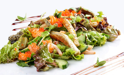 Salad with salmon belly and tobiko caviar on white background