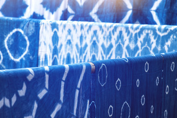 many indigo dyed fabrics, dried at the clothesline background