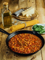 Table with traditional spaghetti bolognese ingredients