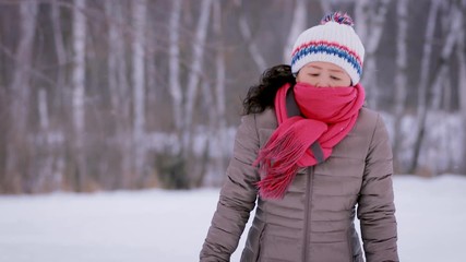 Asain woman freezing on a cold winter day.