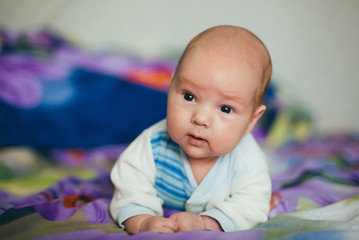 little newborn Caucasian white baby boy lying