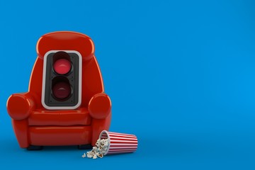 Red traffic light with theater armchair and popcorn