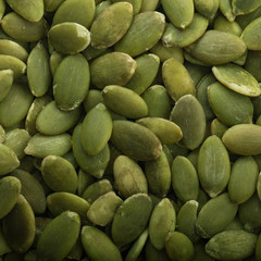 heap of shelled pumpkin seeds background