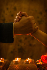 Handshake men and women at dinner by candlelight.