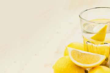 Glass of water with piece of lemon or fresh hand made lemonade