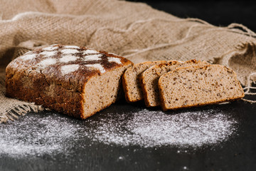 Fresh baked bread on fabric on the black background