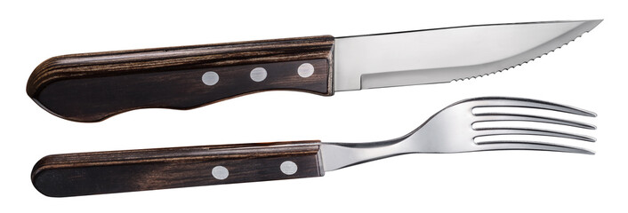 Steak cutlery set close-up. Steel fork and knife with wooden handle. File contains clipping path.