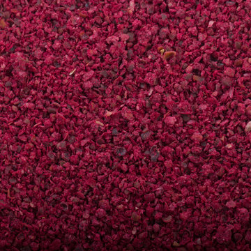 dried pomegranate seeds powder background