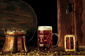 The wooden barrel background with lots of gold coins and a large mug of beer with a green bow....