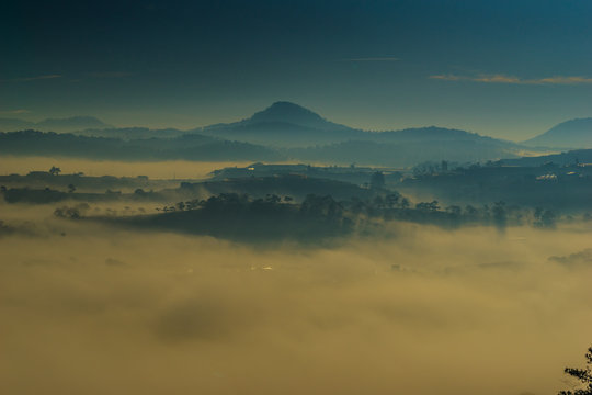 the fog and the sun in an early morning  at Da Lat city, the pine hill and greenhouse under the hill in mist