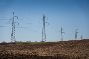 cultivated field and poles of electric current