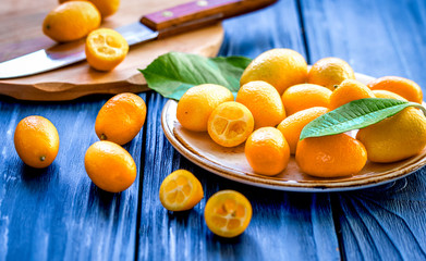 kumquat on plate at wooden table