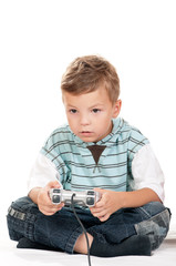 Happy little Boy Playing Video Games. Child using video game Controller. Kid with Joystick playing Computer Game on white background.