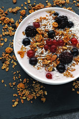 Healthy breakfast bowl with yogurt, granola and berries. Keto diet. Concept proper breakfast. Flat Lay.