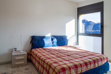 Bright bedroom with window overlooking the mountains