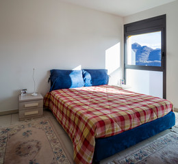 Bright bedroom with window overlooking the mountains