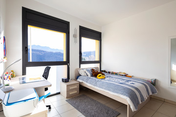 Bright bedroom with window overlooking the mountains