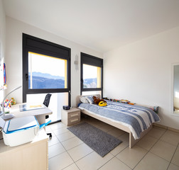 Bright bedroom with window overlooking the mountains