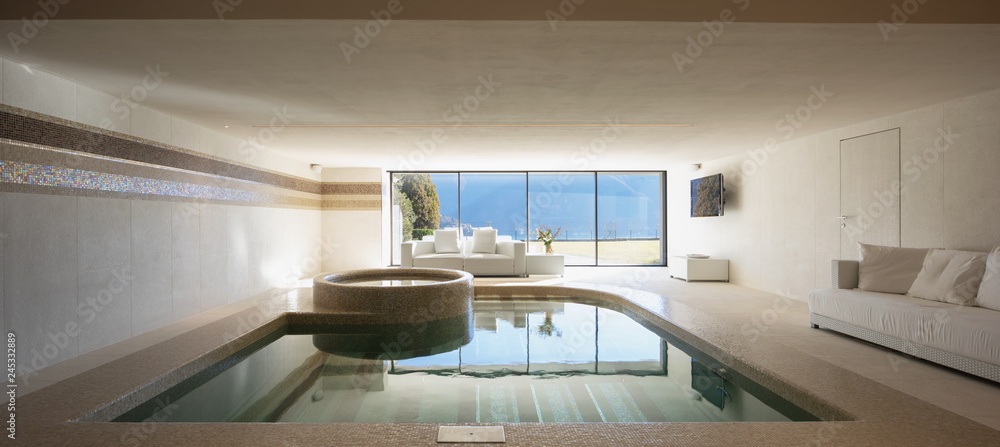 Wall mural Indoor pool of private villa with lake view and bar area