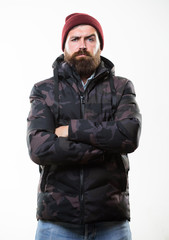 Comfortable winter outfit. Winter stylish menswear. Man stand warm camouflage pattern jacket parka...