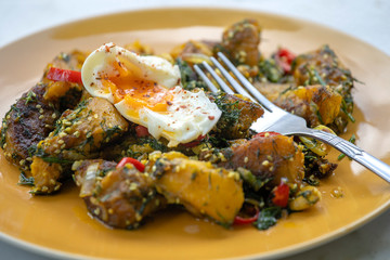 Fried pumpkin with spices together soft-boiled egg