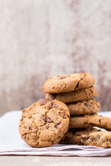 Chocolate oatmeal cookies on the wooden background.