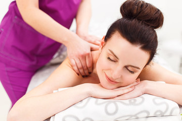 Fototapeta na wymiar Beautiful brunette at a massage in a spa