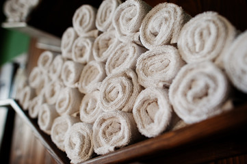 Row of twisted white towels on barbershop.