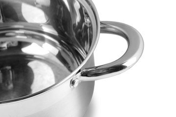 Open stainless steel cooking pot over white background