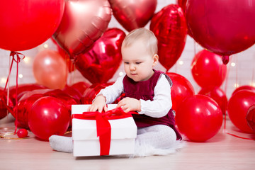 Fototapeta na wymiar valentine's day concept - cute little baby girl with gift box and red balloons